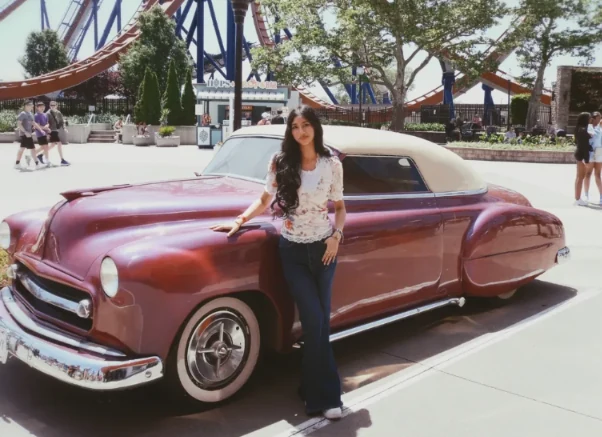 Rafa beside a vintage car